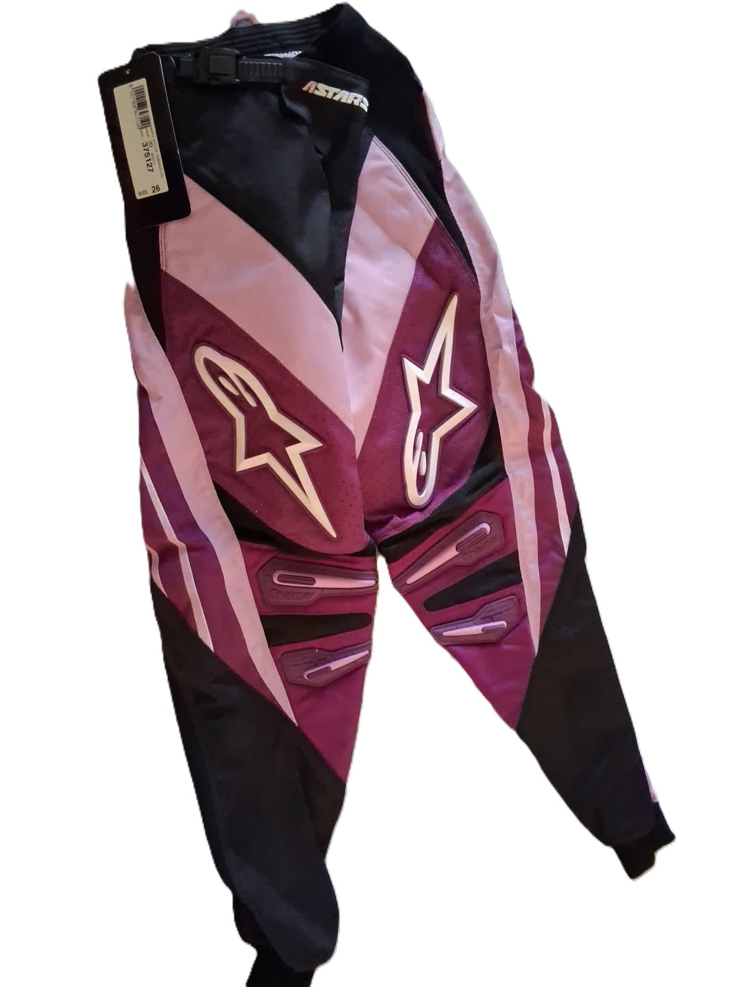 Maroon and black motocross pants with a prominent logo on a white background